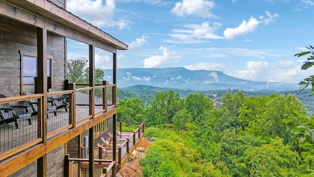 a balcony of a house with a view of the mountains at Honeybear Hideaways - #1 Luxury Haven Cabin with Breathtaking Mountain Views, Indoor Pool, Bowling Alley, and Golf in Pigeon Forge