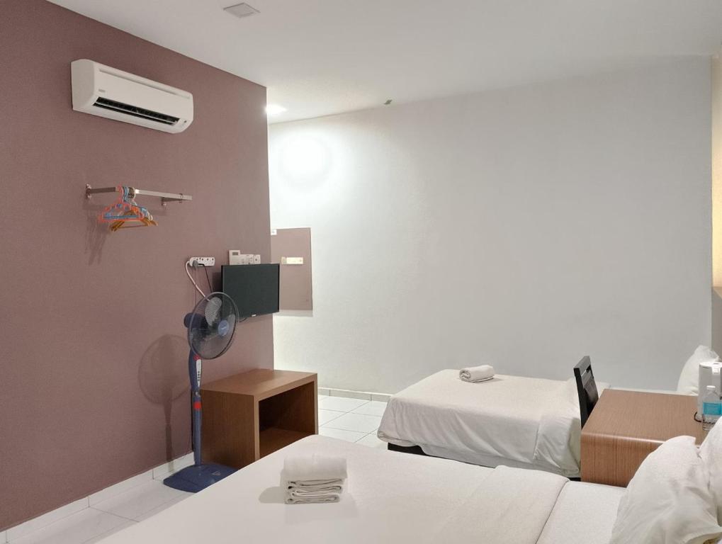Postel nebo postele na pokoji v ubytování Hotel Wawasan