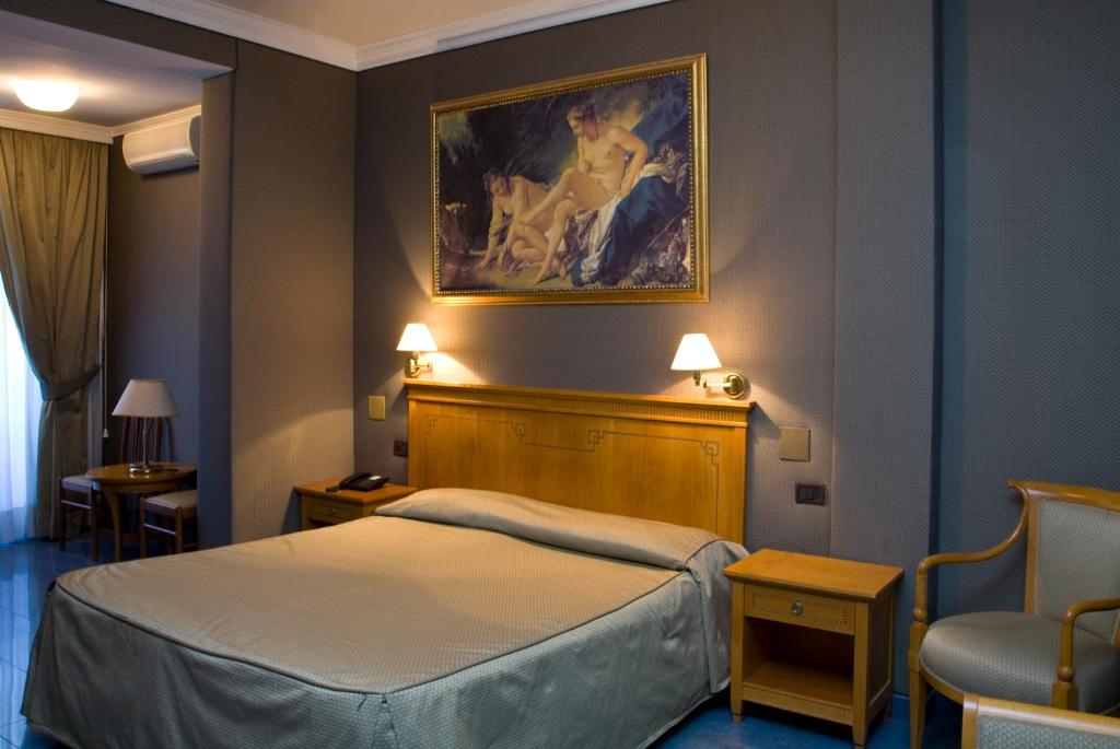 Postel nebo postele na pokoji v ubytování Hotel Rimini