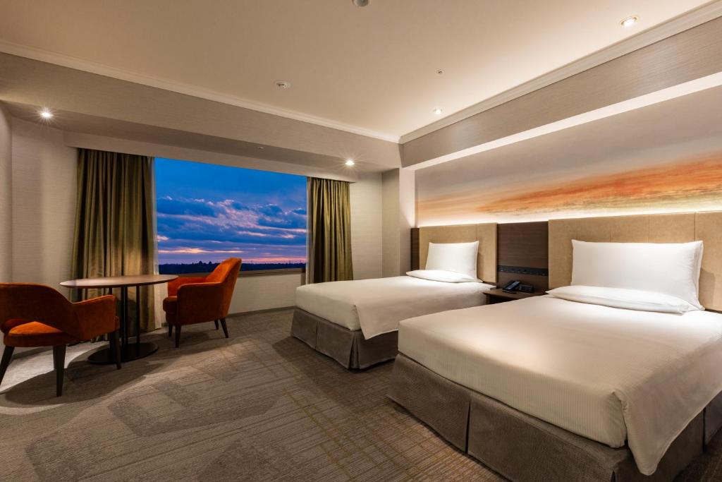 Postel nebo postele na pokoji v ubytování Hilton Tokyo Narita Airport