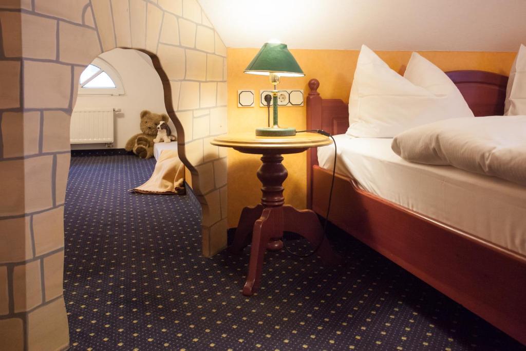 a bedroom with a bed and a table with a lamp at Park Resort in Willingen
