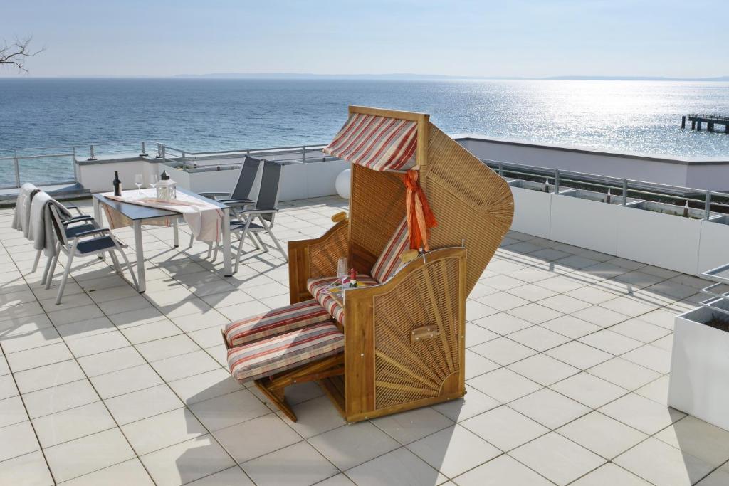 a rocking chair on the deck of a cruise ship at Suite Meersinn in Sassnitz