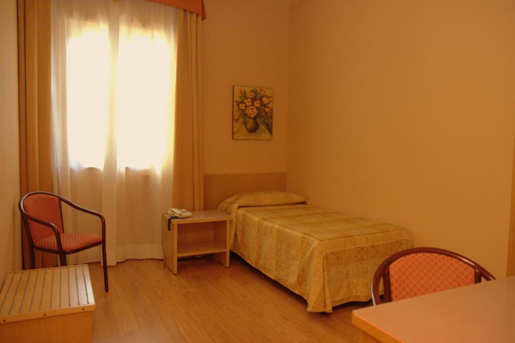 Postel nebo postele na pokoji v ubytování Hotel Tre Torri