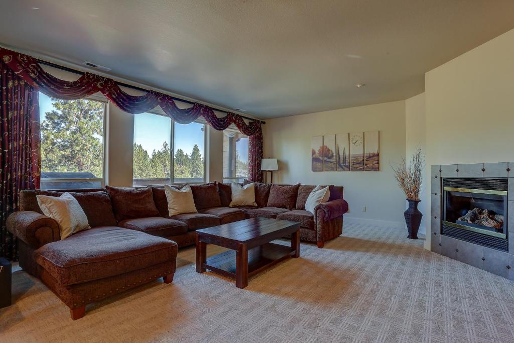 a living room with a couch and a fireplace at Quinn Creek in Bend