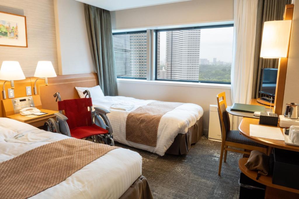 Postel nebo postele na pokoji v ubytování Toshi Center Hotel