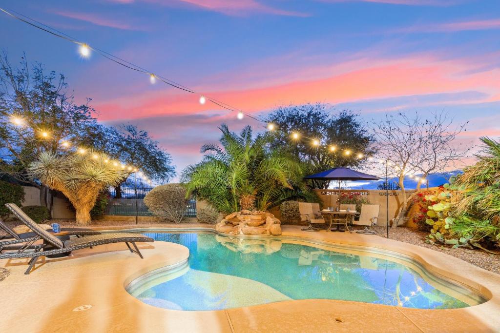 a swimming pool in a yard with a patio and trees at Goodyear Springs in Goodyear