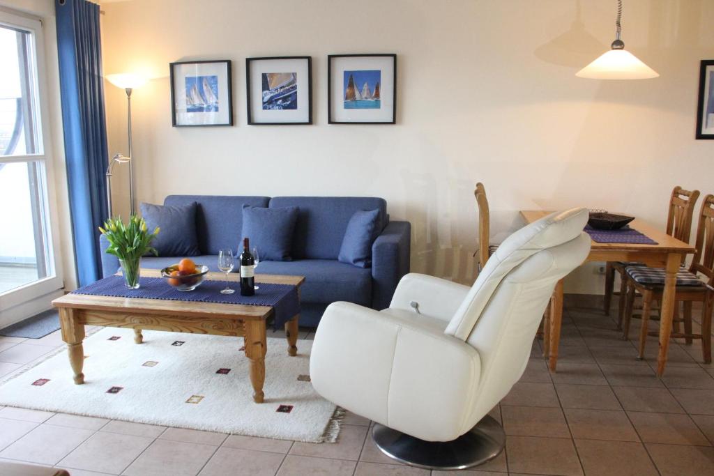 a living room with a couch and a table at Ostseeresidenz - Whg 24 in Groß Kirr