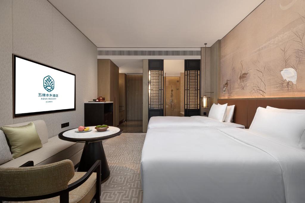 Postel nebo postele na pokoji v ubytování Xiamen Aqua Resort