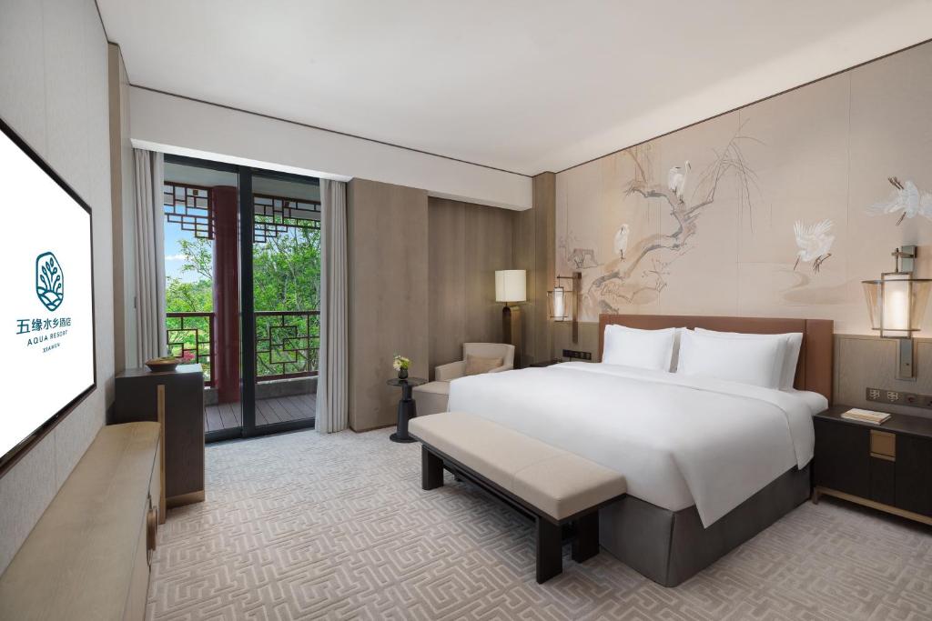 Postel nebo postele na pokoji v ubytování Xiamen Aqua Resort