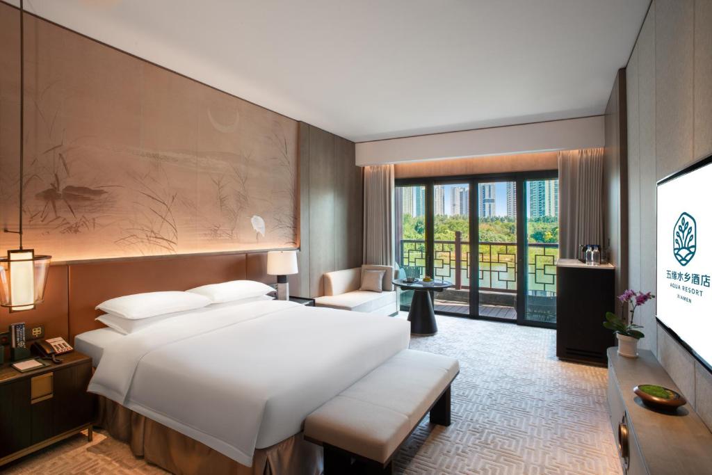 Postel nebo postele na pokoji v ubytování Xiamen Aqua Resort