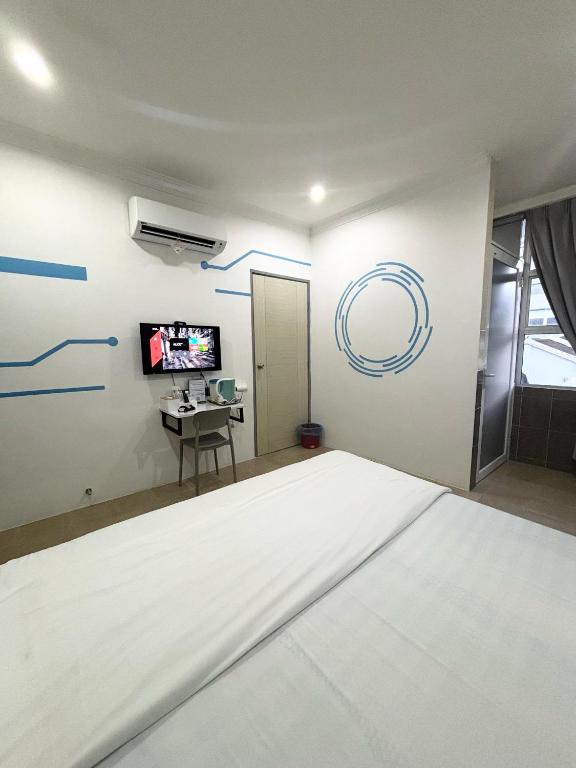 Postel nebo postele na pokoji v ubytování One Stop Hotel Ipoh