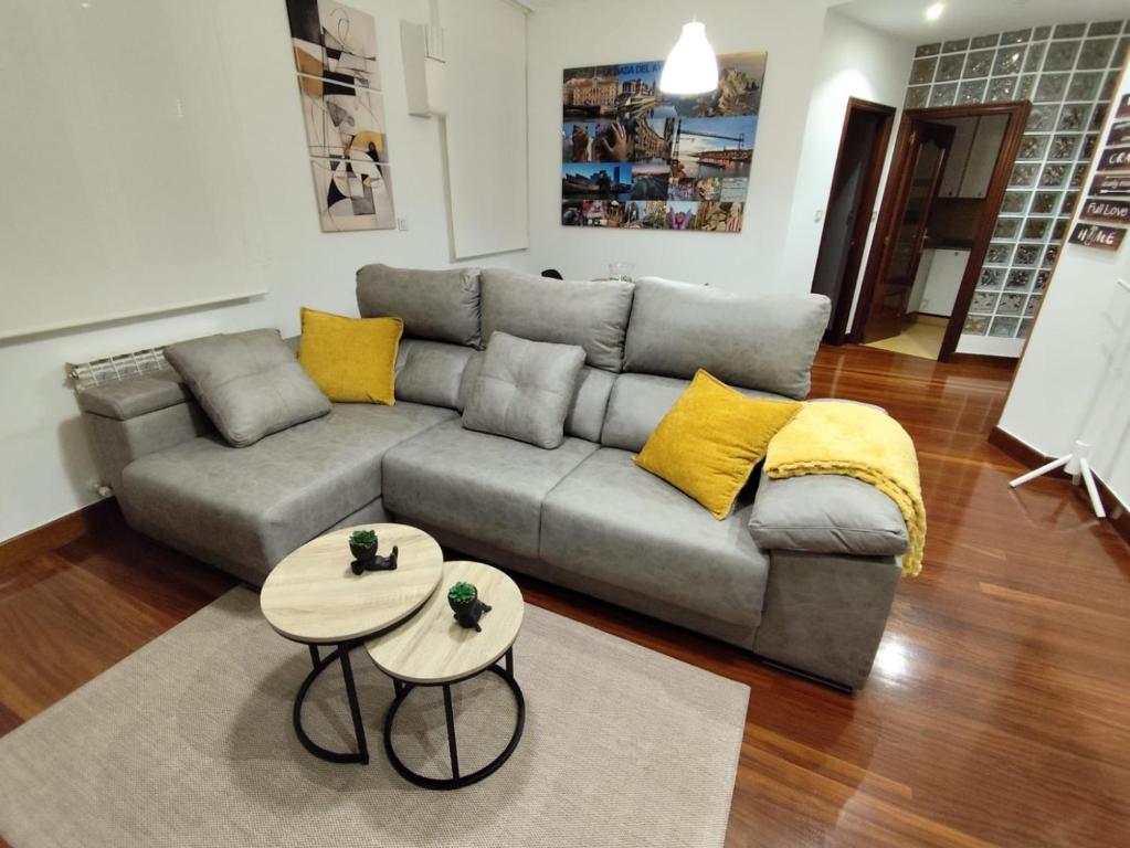 a living room with a couch and two tables at Nuevo, junto al Ayuntamiento y Casco Viejo in Bilbao