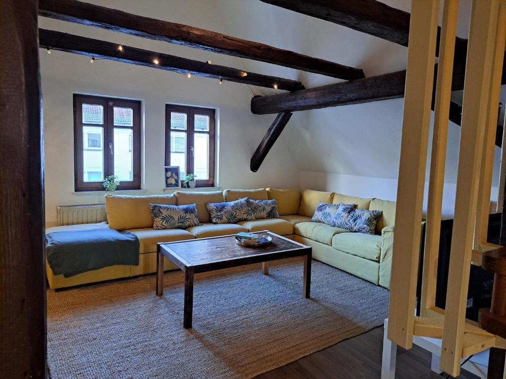 a living room with a couch and a coffee table at Zentrale Altbau Fewo Marktplatz in Gunzenhausen