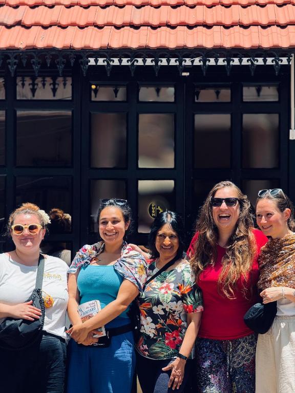 a group of women standing in front of a building at David Residency in Madurai