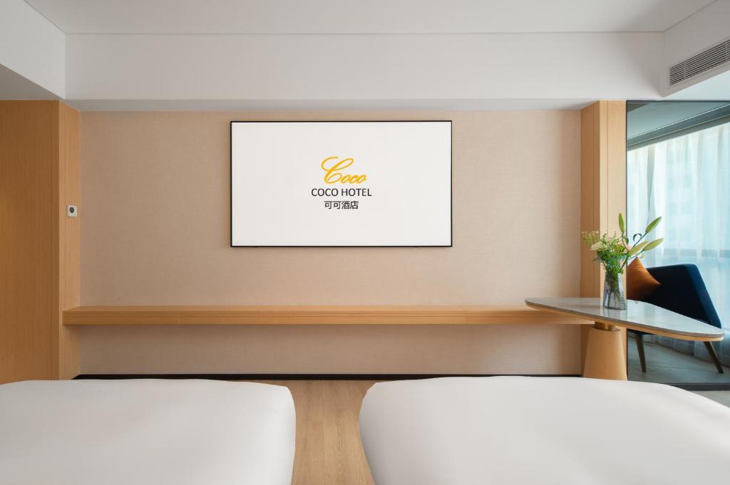 Postel nebo postele na pokoji v ubytování Guangzhou Baiyun Airport COCO Hotel