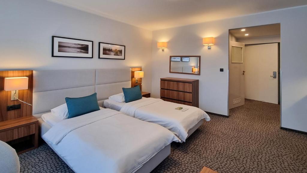 Posteľ alebo postele v izbe v ubytovaní Hotel Wolin