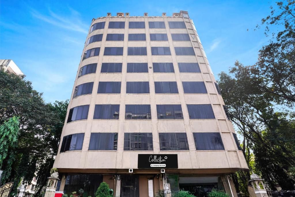 a tall building with a sign in front of it at Collection O Andheri Near Western Express Highway in Mumbai