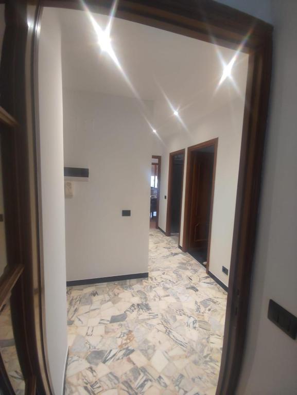 a mirror in a hallway with a tile floor at SWEET HOUSE dolce casa in Campomorone