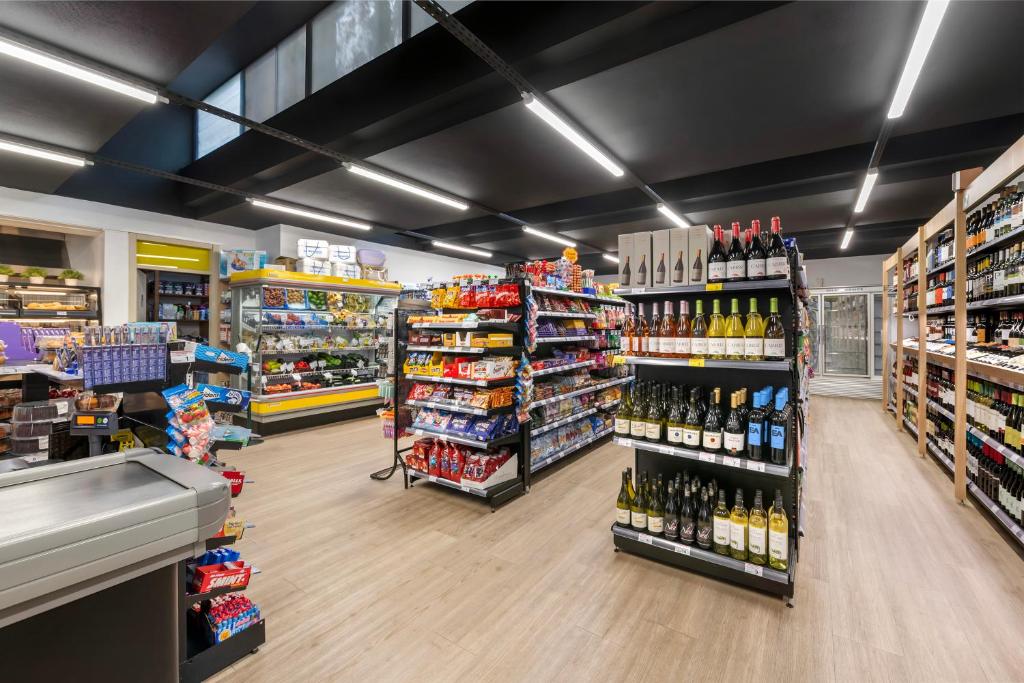 a store aisle of a grocery store filled with alcohol at Vilar do Golf in Quinta do Lago