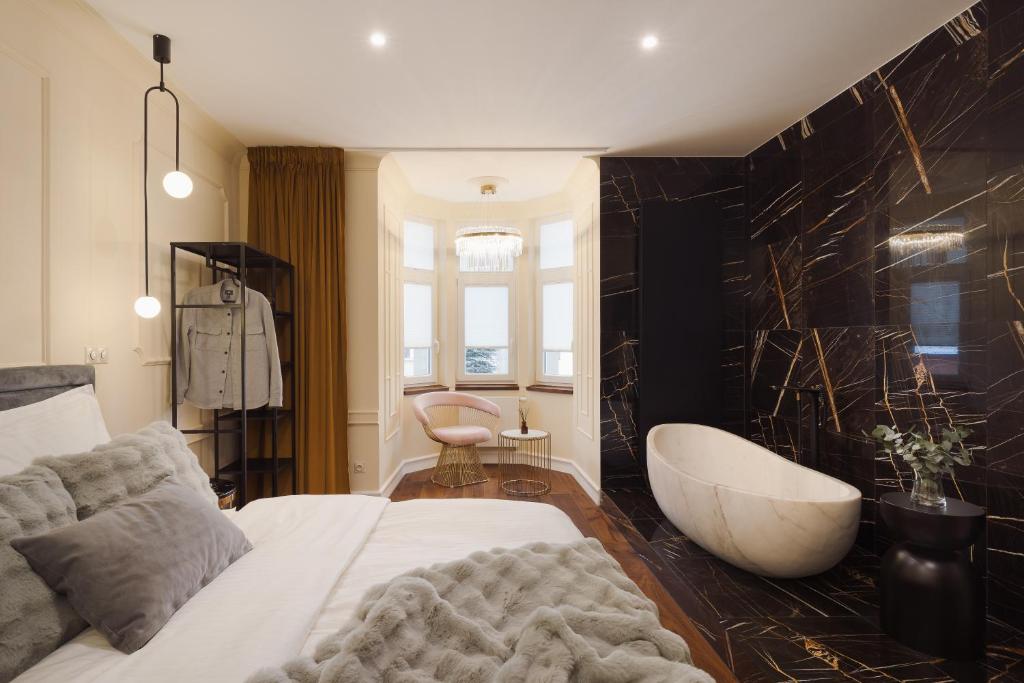 Postel nebo postele na pokoji v ubytování BICE apartments & Wellness