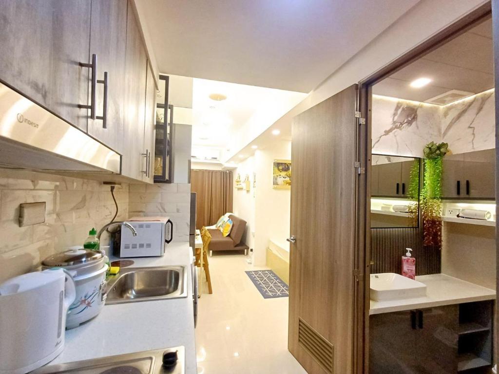 a small kitchen with a sink and a counter at S Residences 942b near airport pasay in Manila