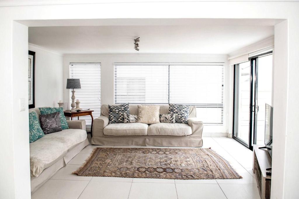 a living room with a couch and a rug at The Views - Oceanview Haven in Langebaan - 3 Levels of Luxury in Langebaan