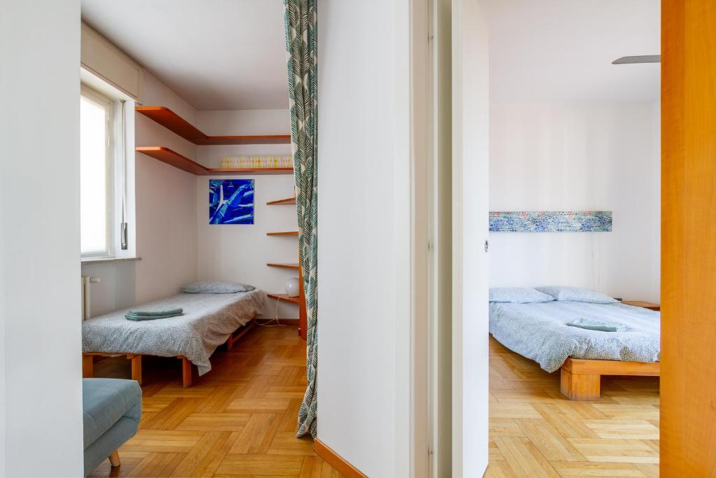 Posteľ alebo postele v izbe v ubytovaní attico con terrazzo navigli bocconi - NavigliApartments