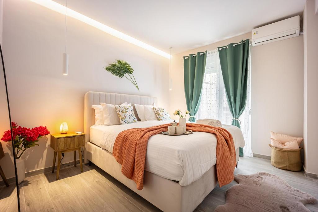 a bedroom with a bed and a window with green curtains at Elegant Aphrodite, 2 Bedroom Apartment, by Acropolin in Athens