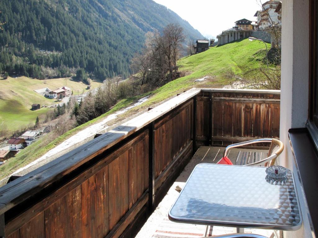 a bench on a balcony with a view of a mountain at Apartment Miramonte-3 by Interhome in Kappl