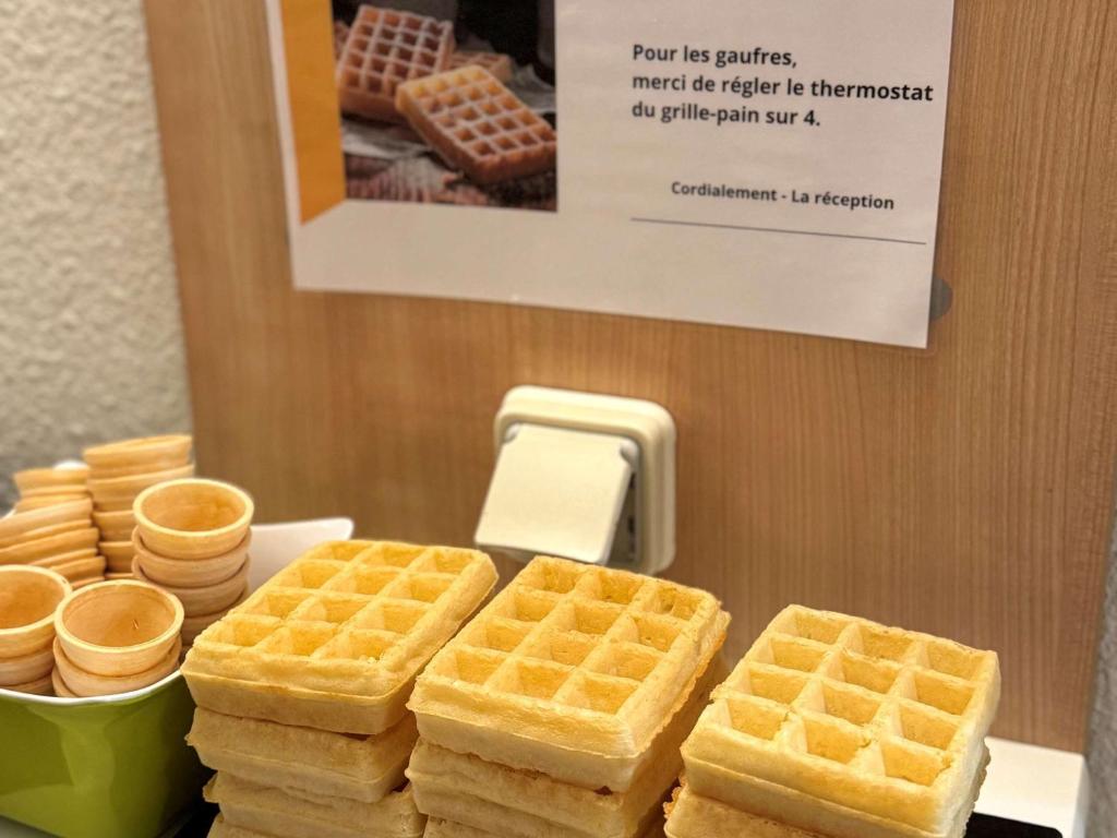 a bunch of waffles sitting on a table with at Hotel Ibis Budget Cosne Sur Loire in Cosne-Cours-sur-Loire