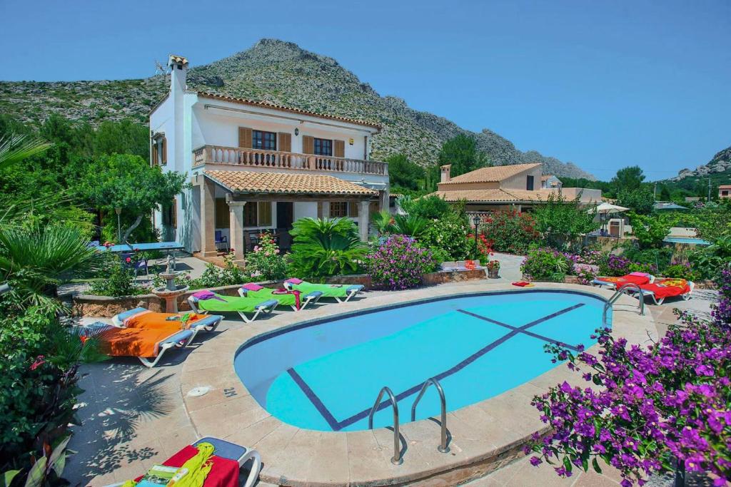 a swimming pool in front of a house at Villa Carla by Sealand Villas in Port de Pollensa