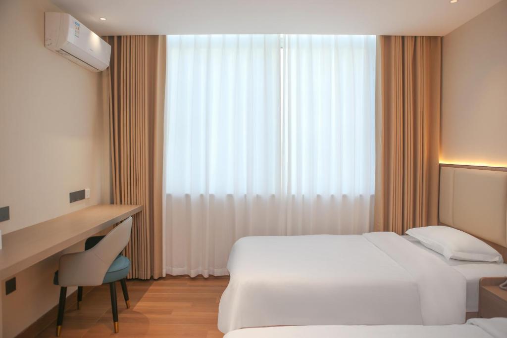 Postel nebo postele na pokoji v ubytování Shenzhen Green Oasis Hotel, Baoan