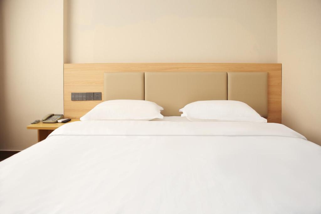 Postel nebo postele na pokoji v ubytování Shenzhen Green Oasis Hotel, Baoan