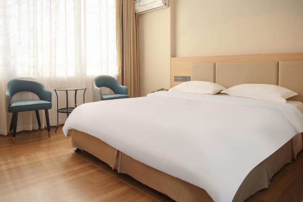 Postel nebo postele na pokoji v ubytování Shenzhen Green Oasis Hotel, Baoan