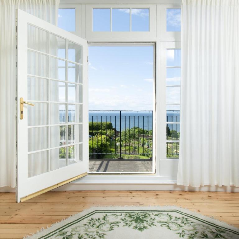 an open door with a view of a balcony at Whatton Cottage in Gullane