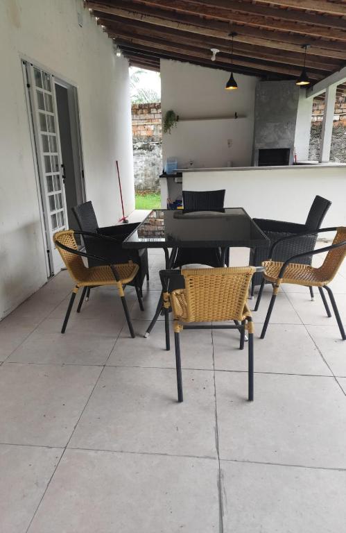a patio with a table and chairs and a piano at Praia do Paraíso in Mosqueiro