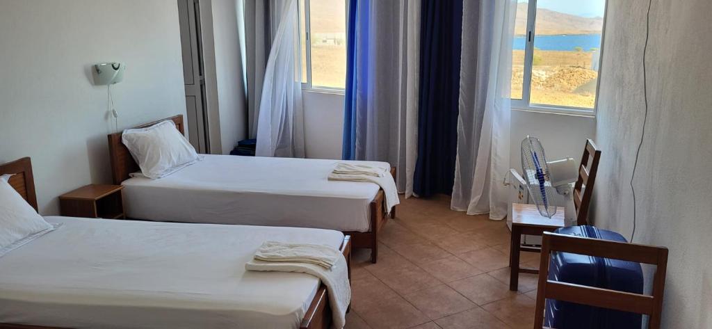 Postel nebo postele na pokoji v ubytování Cacimba Sunset Lodge