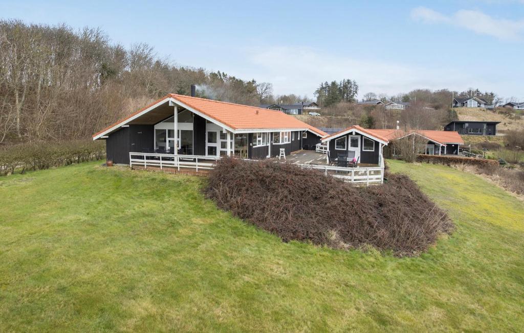 a house on top of a grassy hill at 3 Bedroom Amazing Home In Spøttrup in Lihme