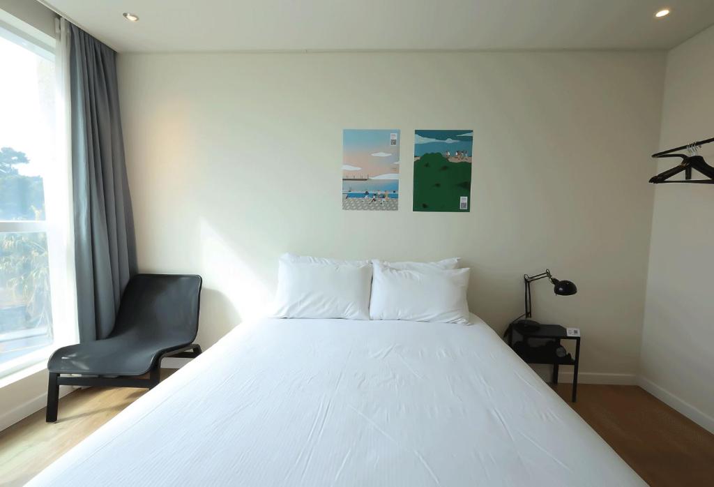 Postel nebo postele na pokoji v ubytování Dodubong Stay Hotel