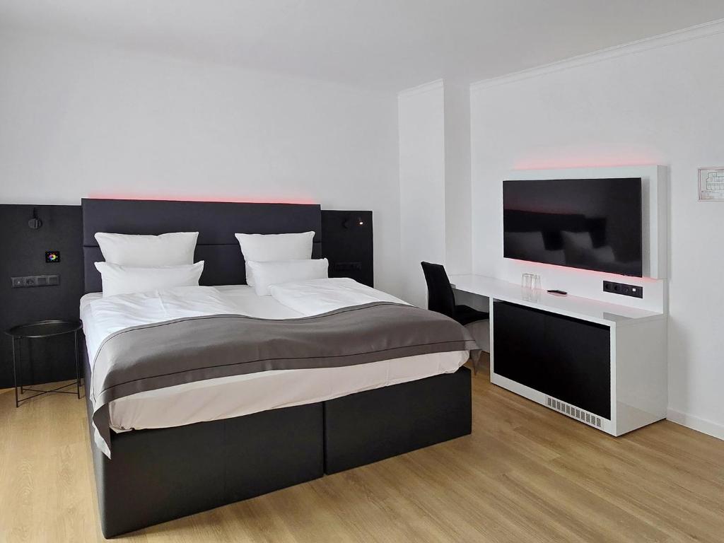 Postel nebo postele na pokoji v ubytování DORMERO Hotel Coburg