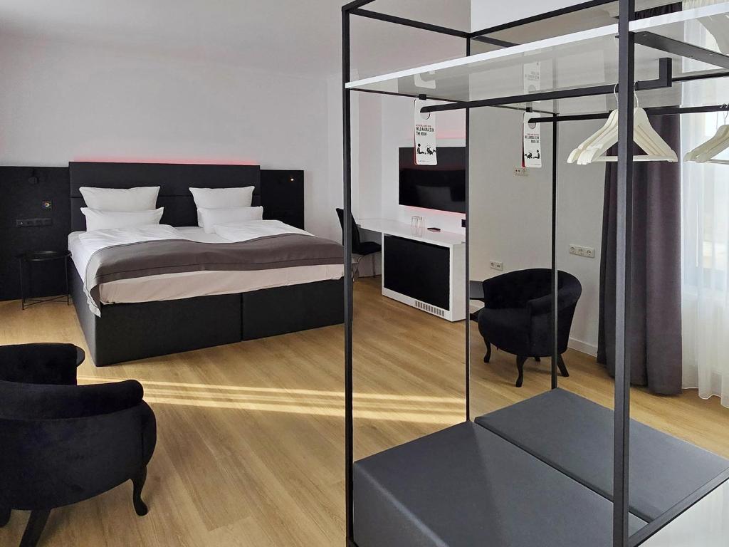 Postel nebo postele na pokoji v ubytování DORMERO Hotel Coburg