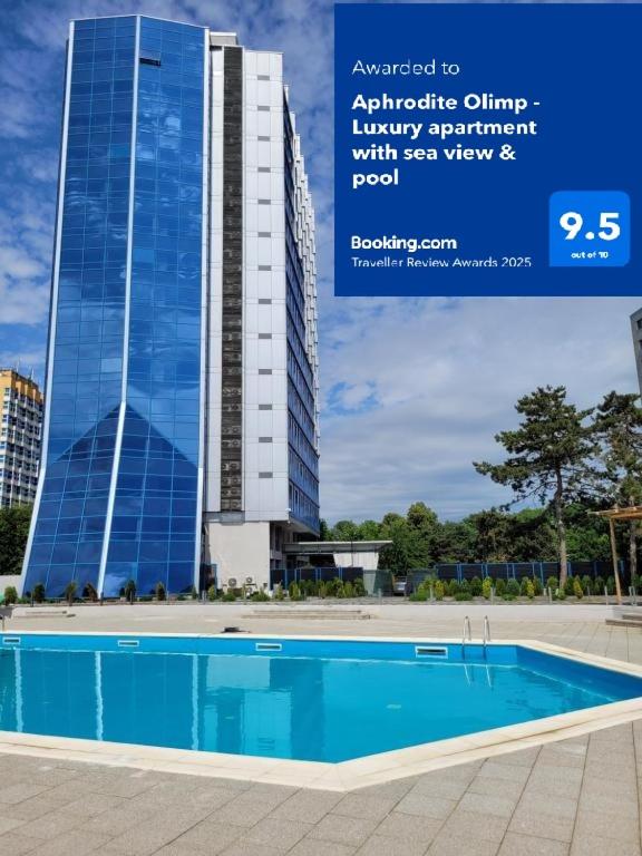 a building with a swimming pool in front of a building at Aphrodite Olimp - Luxury apartment with sea view & pool in Olimp
