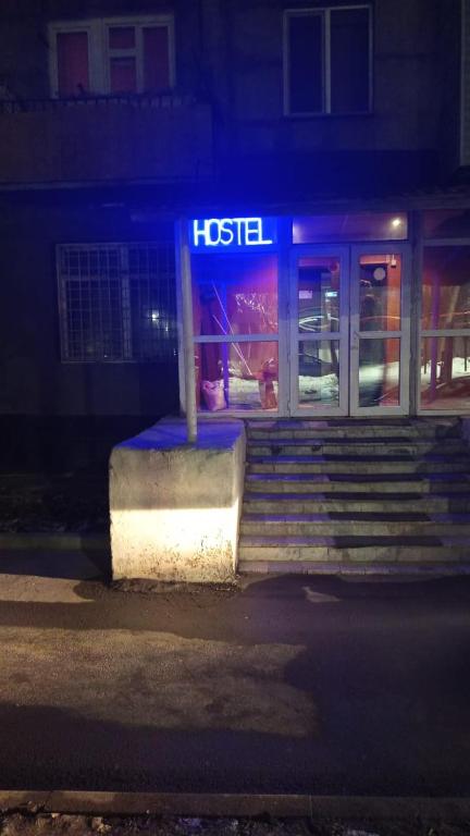 a hotel sign in front of a building at night at Хостел in Almaty