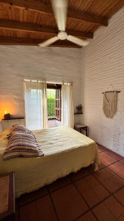 een slaapkamer met een groot bed en een raam bij Casa cercana a plaza de Villa de las Rosas con patio y asador in Villa Las Rosas
