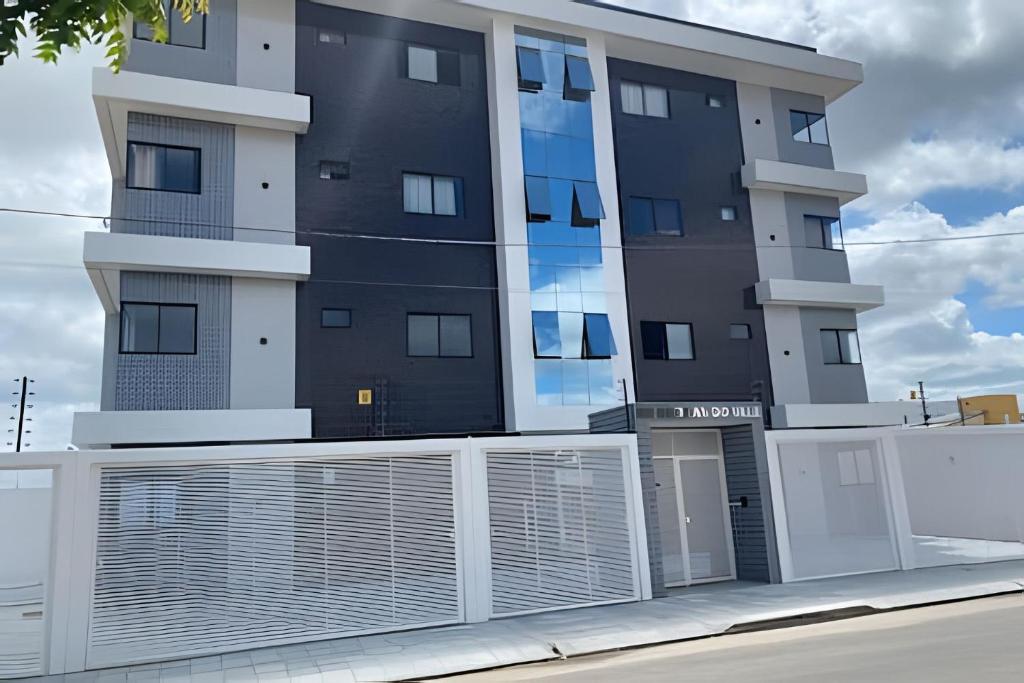 a building with a white fence in front of it at Para 10 pessoas, 03 quartos ar condicionado e ventilador, garagem, atrás do hospital da Unimed apt 302 in Petrolina