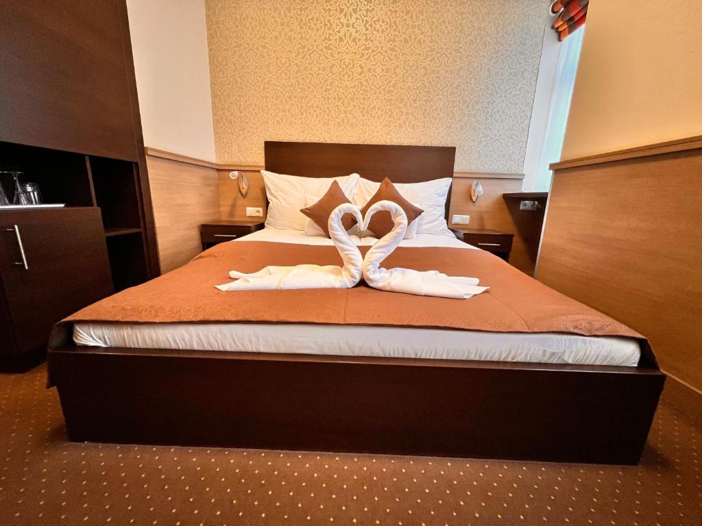 Postel nebo postele na pokoji v ubytování Central Hotel 21 and Apartments