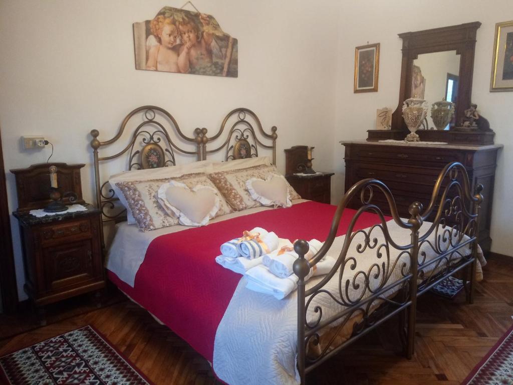 a bedroom with a bed with a doll on it at La casa dei poeti in Cervasca