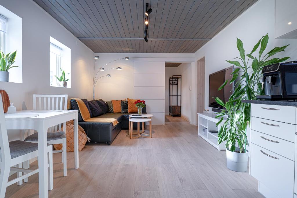 a living room with a couch and a table at KS Apartment Modern & cozy flat 20 min from Bergen centre in Espeland