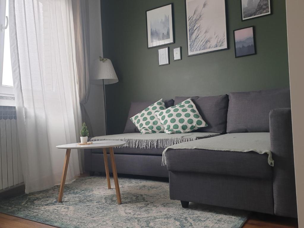 a living room with a couch and a table at Apartma Thermos in Krapinske Toplice