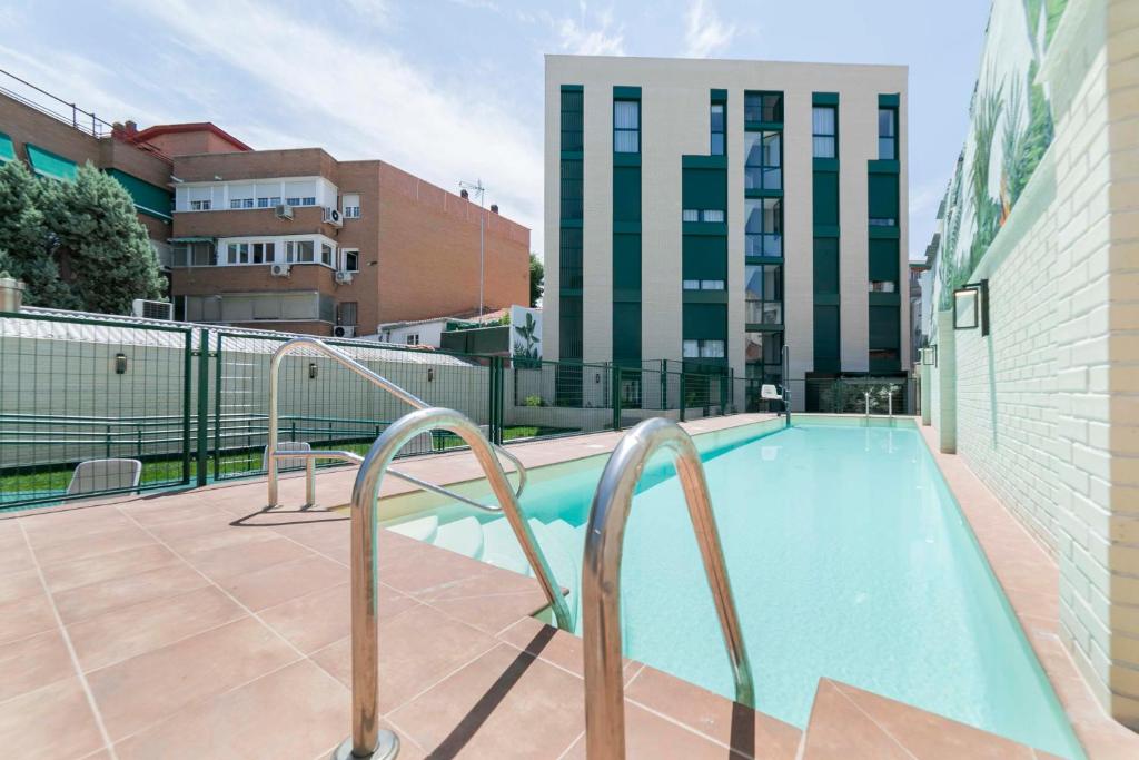 a swimming pool on a balcony of a building at Aurora Stays by Charming - Parking cubierto gratis in Madrid